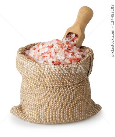 Himalayan salt in sack and wooden scoop inserted on top isolated on white background 124482198