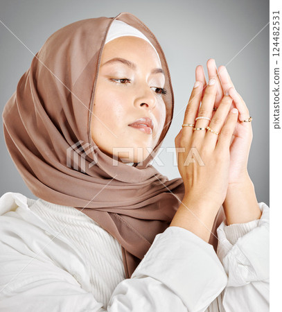 Hijab, jewelry and fashion of woman in islam beauty headshot with makeup or cosmetics in a studio mock up. Arab, muslim or arabic model wearing scarf fabric and ring on hands with mockup background 124482531