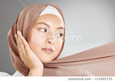 Face, makeup and beauty cosmetics of muslim woman isolated against gray studio background. Skincare, spa facial or female model from Turkey with glowing, beautiful flawless skin and traditional hijab Face, makeup and beauty cosmetics of muslim woman isolated against gray studio background. Skincare, spa facial or female model from Turkey with glowing, beautiful flawless skin and traditional hijab 124482535