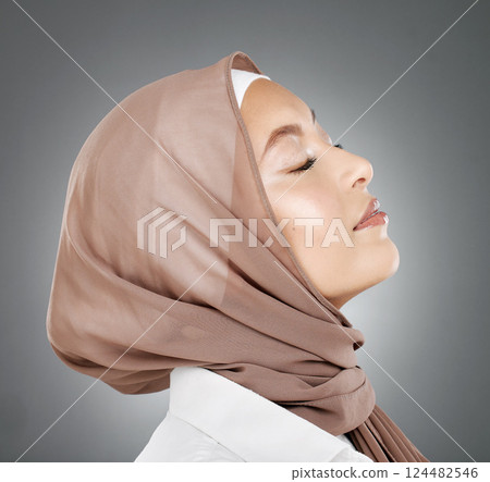Woman, muslim and beauty in hijab scarf embracing islamic religion against a grey studio background. Beautiful head of female model in islam with calm, peaceful face in makeup, cosmetic or treatment Woman, muslim and beauty in hijab scarf embracing islamic religion against a grey studio background. Beautiful head of female model in islam with calm, peaceful face in makeup, cosmetic or treatment 124482546