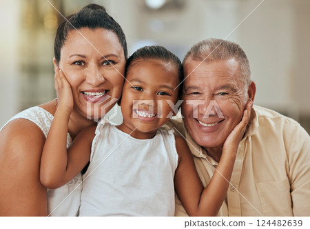 Family, portrait and face of girl with grandparents in living room, relax and bonding in their home together. Love, happy family and child enjoy quality time with grandma and grandpa on the weekend 124482639