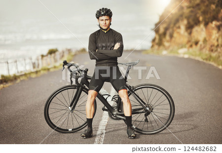 Man, cycling and mountain bike with arms crossed for sports exercise, training and fitness in nature. Portrait of a confident male professional cyclist standing by a bike for cycle tour outdoors 124482682
