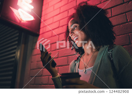 Black woman, phone and night in city with smile on social media, app or communication on travel, tourist or adventure. Woman, smartphone and metro on web, internet or chat for happiness on smartphone Black woman, phone and night in city with smile on social media, app or communication on travel, tourist or adventure. Woman, smartphone and metro on web, internet or chat for happiness on smartphone 124482908