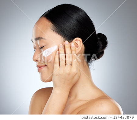Beauty, skin and woman, cream and natural cosmetic advertising for face, moisturizing product and skincare with grey studio background. Asian model, facial treatment and body care, fresh and glow. 124483079
