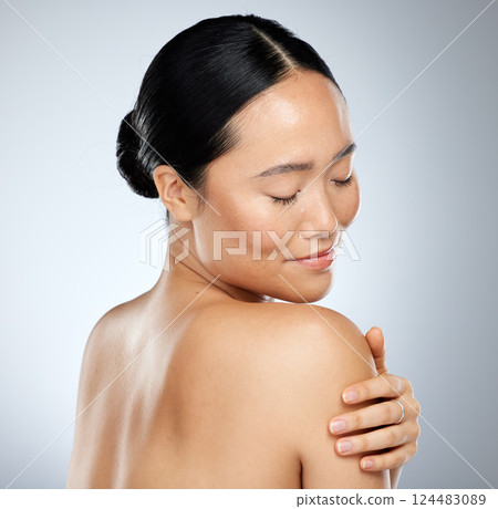 Beauty, skincare and body cream with woman touching her shoulder and skin after routine dermatology therapy. Smile, happy and natural asian girl and model posing for wellness, health and cosmetics Beauty, skincare and body cream with woman touching her shoulder and skin after routine dermatology therapy. Smile, happy and natural asian girl and model posing for wellness, health and cosmetics 124483089