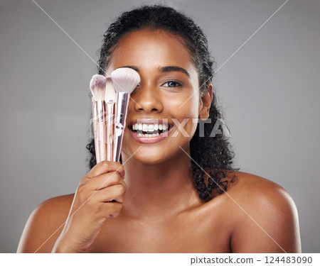 Makeup, beauty and portrait of woman with brush to apply foundation, skincare product or luxury facial cosmetics. Wellness, health and happy aesthetic face of model girl isolated on gray background 124483090