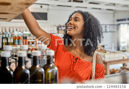 Supermarket, shelf and shopping customer woman retail store for eco friendly product, olive oil or groceries choice. Happy woman in small business store marketplace with choice or food sale discount Supermarket, shelf and shopping customer woman retail store for eco friendly product, olive oil or groceries choice. Happy woman in small business store marketplace with choice or food sale discount 124483158