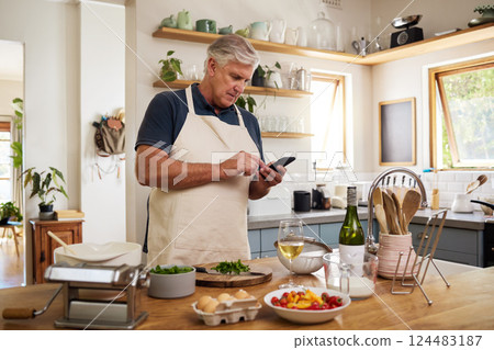 Senior man, retirement and cooking in kitchen, smartphone and search internet for food recipe, technology and online connection. Healthy diet, chef skill development and research meal ideas. 124483187