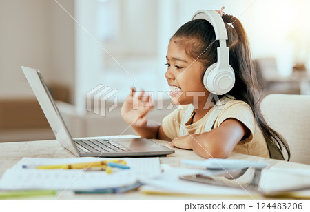 Video call, online education and child with laptop, headphones and home table for e learning virtual class. Hello, zoom call and girl kid in elearning school listening to audio kindergarten language 124483206