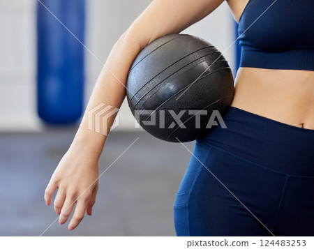 Fitness, exercise and woman with medicine ball in a health and wellness gym for training or weight exercise. Female athlete arm with workout equipment for strong body and cardio sport exercising 124483253