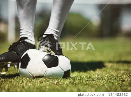 Soccer player feet, deflated soccer ball and sports, competition game and training on grass field, pitch and lawn. Closeup footballer boots puncture, broken and decrease air problem of flat equipment 124483282