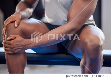 Fitness, sports and knee injury of man holding painful area after intense exercise, workout or training at the gym. Hands of muscular male suffering from sore leg pain, joint or muscle inflammation Fitness, sports and knee injury of man holding painful area after intense exercise, workout or training at the gym. Hands of muscular male suffering from sore leg pain, joint or muscle inflammation 124483309