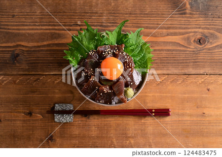 Pickled tuna rice bowl topped with egg yolk Pickled tuna rice bowl topped with egg yolk 124483475