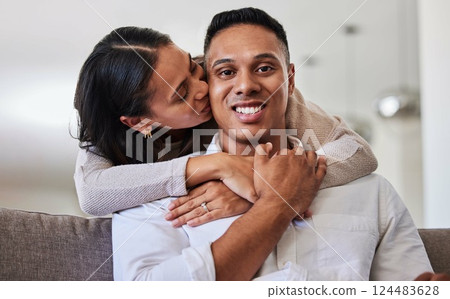 Couple, kiss and cheek for hug, love and care relationship romance relaxing on the living room sofa at home. Portrait of happy man and woman with smile for romantic bonding time together at the house 124483628