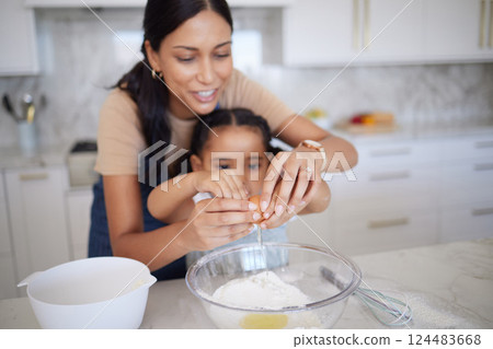 Egg, baking and family with a mother and girl learning how to bake in the kitchen of their home together. Food, kids and cooking with a woman teaching her daughter how to be a chef or cook in a house Egg, baking and family with a mother and girl learning how to bake in the kitchen of their home together. Food, kids and cooking with a woman teaching her daughter how to be a chef or cook in a house 124483668