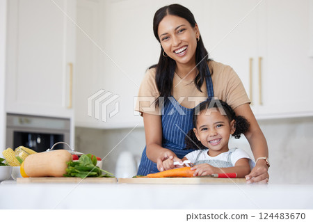 Happy family, girl or child learning from mother cooking or kitchen skills with healthy organic food vegetables. Smile, development and mom teaching or helping young kid with lunch or dinner at home 124483670