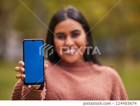 Green screen, girl and hands with phone portrait for online alert, notification or communication. Marketing, internet and app advertising Indian woman in nature with mobile mock up in foreground. 124483674