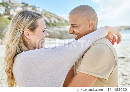Couple, love and hug on the beach smile for romantic date, anniversary or engagement announcement. Happy people show commitment care, happiness and trust by the sea and ocean water together 124483680