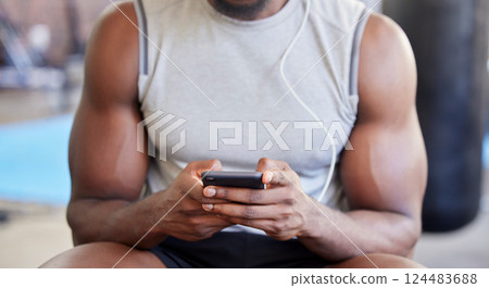 Fitness, hands and phone in gym with man after workout, training or wellness exercise with social media. Strong, muscular and black man text contact, internet or web app in a health and wellness club 124483688