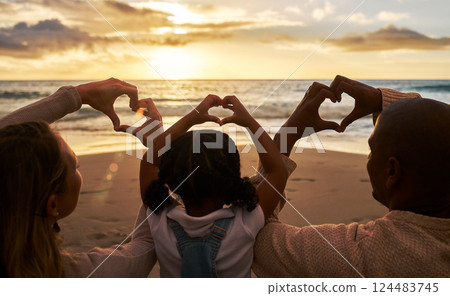 Beach, heart hands and family for love of summer, ocean and outdoor wellness with parents, child and sunset sky clouds . Behind of people, or mother and father with kid with care sign or icon for sea Beach, heart hands and family for love of summer, ocean and outdoor wellness with parents, child and sunset sky clouds . Behind of people, or mother and father with kid with care sign or icon for sea 124483745