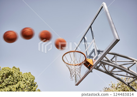 Basketball, point and ball in basket for winning score on basketball court in park with summer sky. Game, sports goals and training practice with motion, action and motivation for winner shot in hoop Basketball, point and ball in basket for winning score on basketball court in park with summer sky. Game, sports goals and training practice with motion, action and motivation for winner shot in hoop 124483814