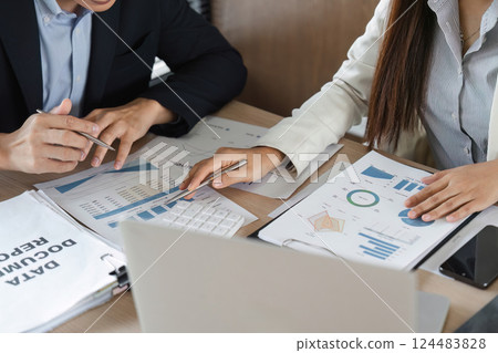 Data Presentation and Review. Professionals evaluating marketing performance by reviewing charts and financial data together. 124483828