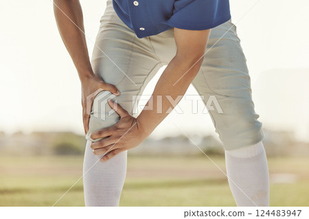 Sports man, knee injury and athlete with leg muscle strain on baseball field ground of pitch at athletic training ball game. Exercise accident, joint pain and outdoor fitness workout in Dallas Texas Sports man, knee injury and athlete with leg muscle strain on baseball field ground of pitch at athletic training ball game. Exercise accident, joint pain and outdoor fitness workout in Dallas Texas 124483947