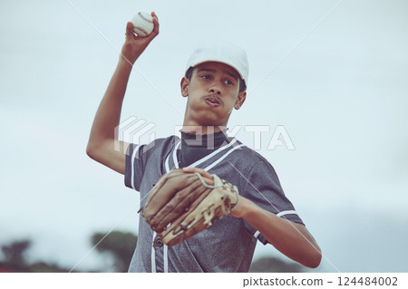 Baseball, sports and fitness with a man athlete throwing a ball during a game or match outside. Workout, training and exercise with a male baseball player playing a competitive sport for health Baseball, sports and fitness with a man athlete throwing a ball during a game or match outside. Workout, training and exercise with a male baseball player playing a competitive sport for health 124484002