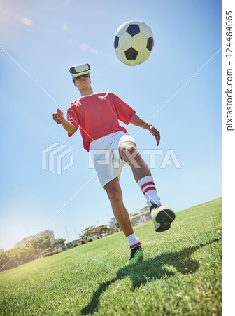 Soccer player, vr and football for kick with man outdoor on field, pitch or park in sunshine. Football play, virtual reality and metaverse for training, exercise or workout in summer with soccer ball 124484065