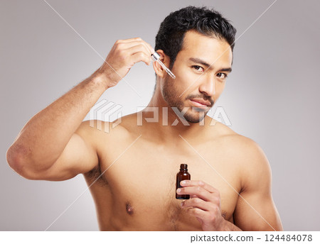 Beauty, portrait and serum with man in studio for natural cosmetics or dermatology routine. Aesthetic, facial treatment and skincare with shirtless model on gray background for antiaging cosmetology 124484078