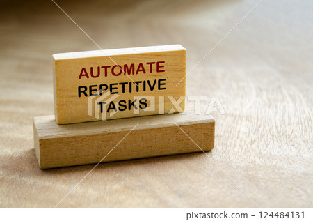 Automate Repetitive Tasks text on wooden block with customizable space for text 124484131