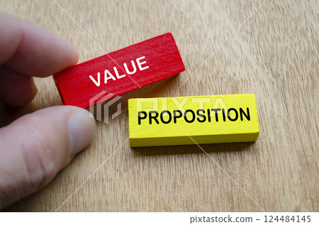 Hand holding Value Proposition text on colored wooden blocks 124484145