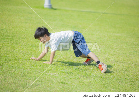 Boy running on the grass 124484205
