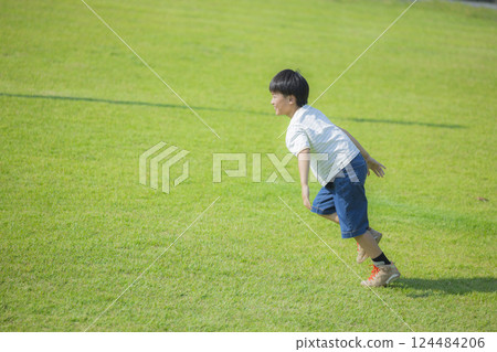 Boy running on the grass 124484206