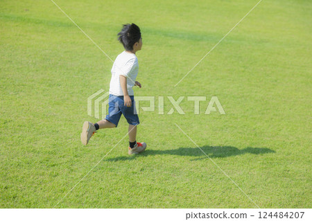 Boy running on the grass 124484207