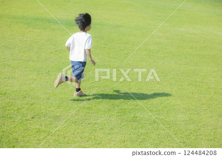 Boy running on the grass 124484208