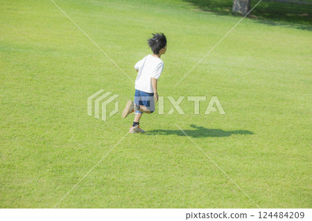 Boy running on the grass 124484209