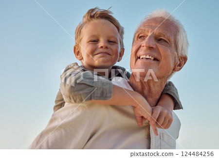 Piggyback, child and grandfather with smile in nature for freedom, love and relax with a blue sky. Portrait of a young, happy and playful kid being funny, bonding and crazy with a senior man in park Piggyback, child and grandfather with smile in nature for freedom, love and relax with a blue sky. Portrait of a young, happy and playful kid being funny, bonding and crazy with a senior man in park 124484256