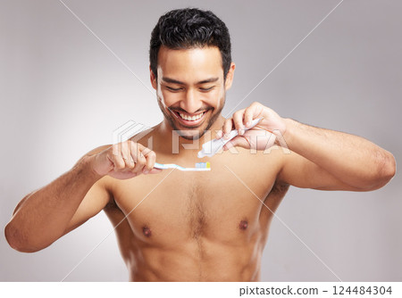 Studio, man and toothpaste with brush for dental, hygiene and wellness with happiness for self care. Smile, male person and model with oral product for gum health, teeth whitening and gray background Studio, man and toothpaste with brush for dental, hygiene and wellness with happiness for self care. Smile, male person and model with oral product for gum health, teeth whitening and gray background 124484304
