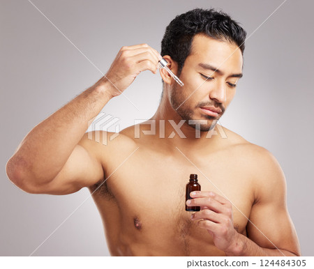 Skincare, man and serum oil in studio for skin hydration, anti aging treatment and collagen. Topless person, cosmetic dropper or dermatology product for natural face moisturizer on gray background Skincare, man and serum oil in studio for skin hydration, anti aging treatment and collagen. Topless person, cosmetic dropper or dermatology product for natural face moisturizer on gray background 124484305