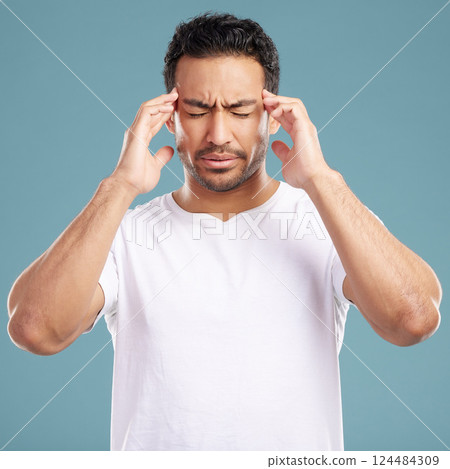 Headache, stress and man in studio with anxiety, burnout or frustrated by brain fog on blue background. Vertigo, face and male model with temple massage for pain, migraine or tension or strain Headache, stress and man in studio with anxiety, burnout or frustrated by brain fog on blue background. Vertigo, face and male model with temple massage for pain, migraine or tension or strain 124484309