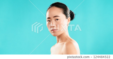 Portrait, skincare and Asian woman with cosmetics, dermatology and glow on blue studio background. Japanese person, confidence and model with healthy skin, shine and grooming with mockup space 124484322