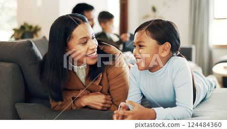 Smile, love and mother with daughter on sofa for bonding, care and comfort together. Support, happiness and couch with woman and child in living room of family home for commitment, relax or growth 124484360