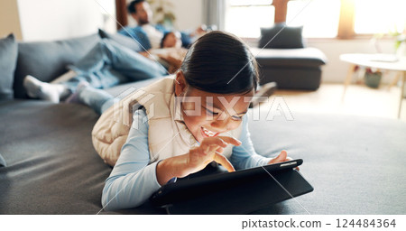 Home, child and girl with tablet for game, entertainment and online fun with technology on sofa. Couch, parents and happy kid with tech for application, streaming and scroll on website in living room Home, child and girl with tablet for game, entertainment and online fun with technology on sofa. Couch, parents and happy kid with tech for application, streaming and scroll on website in living room 124484364