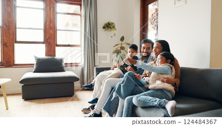 Relax, watching tv and smile with family on sofa for bonding, show and streaming. Movie, happiness and connection with parents and children in living room of home for commitment, love or film Relax, watching tv and smile with family on sofa for bonding, show and streaming. Movie, happiness and connection with parents and children in living room of home for commitment, love or film 124484367