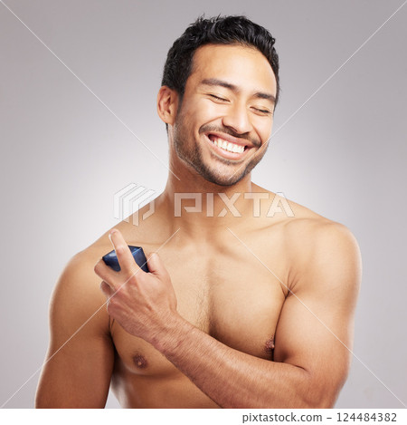 Perfume, man or happy with spray in studio for odor protection, fresh fragrance or grooming routine. Space, topless person or smile with cologne on gray background for hygiene, cosmetics or self care Perfume, man or happy with spray in studio for odor protection, fresh fragrance or grooming routine. Space, topless person or smile with cologne on gray background for hygiene, cosmetics or self care 124484382