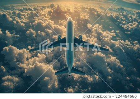 Plane flying high above clouds during sunset 124484660