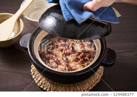 Firefly squid rice cooked in a clay pot Firefly squid rice cooked in a clay pot 124486377