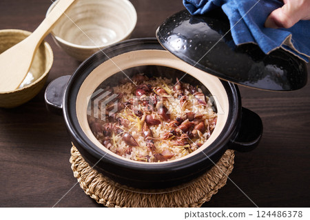 Firefly squid rice cooked in a clay pot Firefly squid rice cooked in a clay pot 124486378