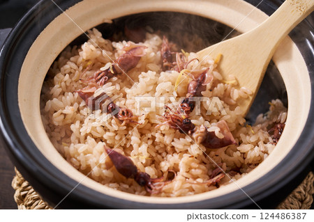 Firefly squid rice cooked in a clay pot Firefly squid rice cooked in a clay pot 124486387